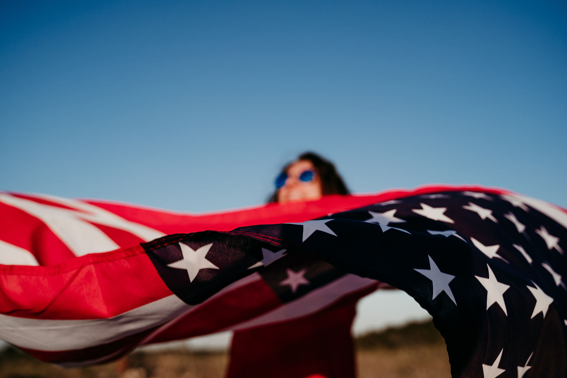 Young woman holding a United States flag